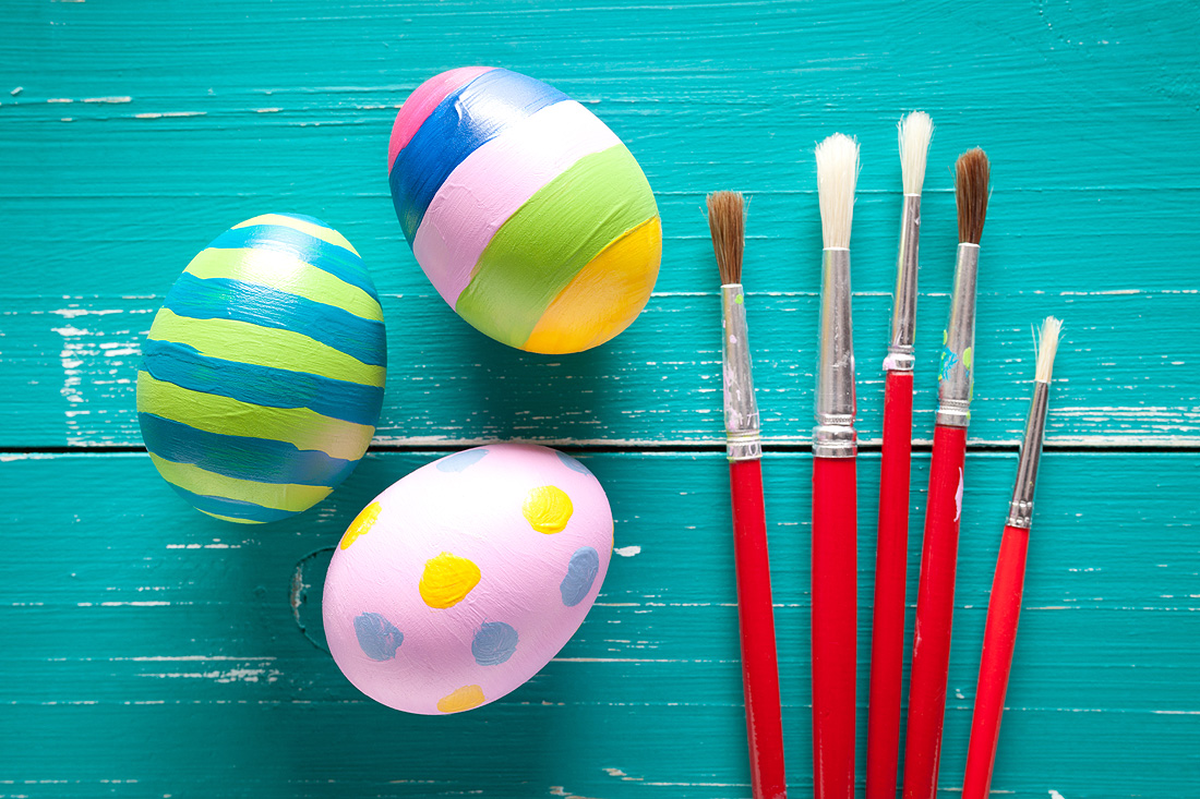 Colorful easter eggs on turquoise wooden table