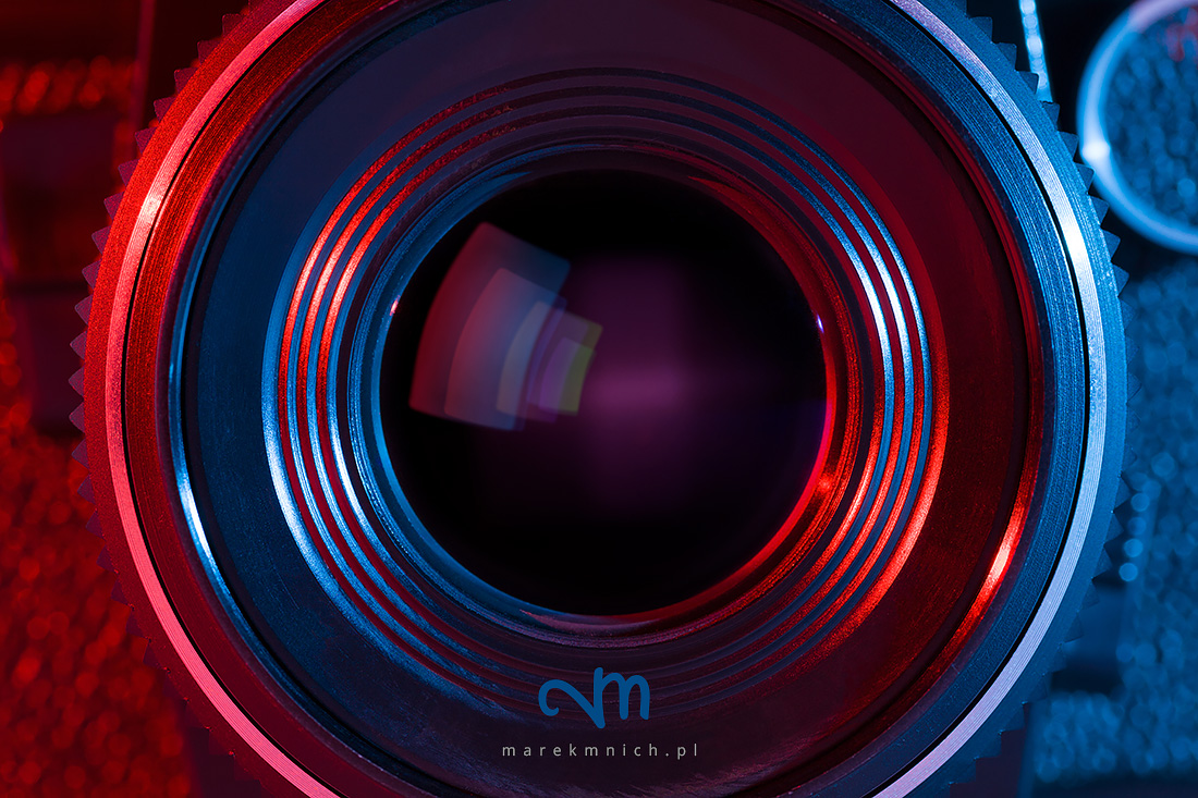 Close up of retro camera lens with red and blue lighting