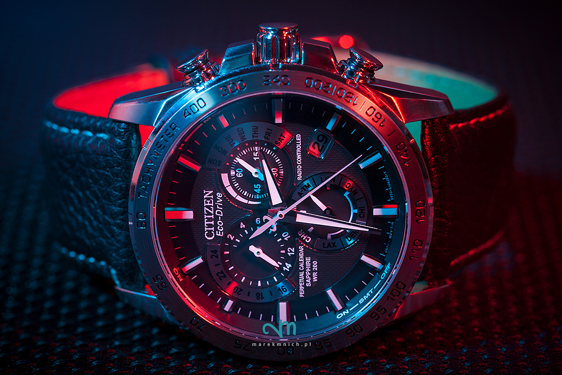 Citizen wristwatch illuminated with red an blue light