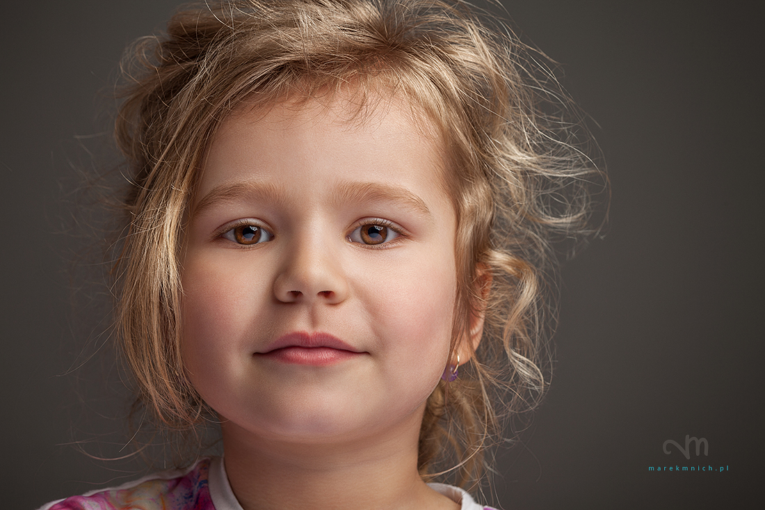 Disheveled cute little girl on grey background