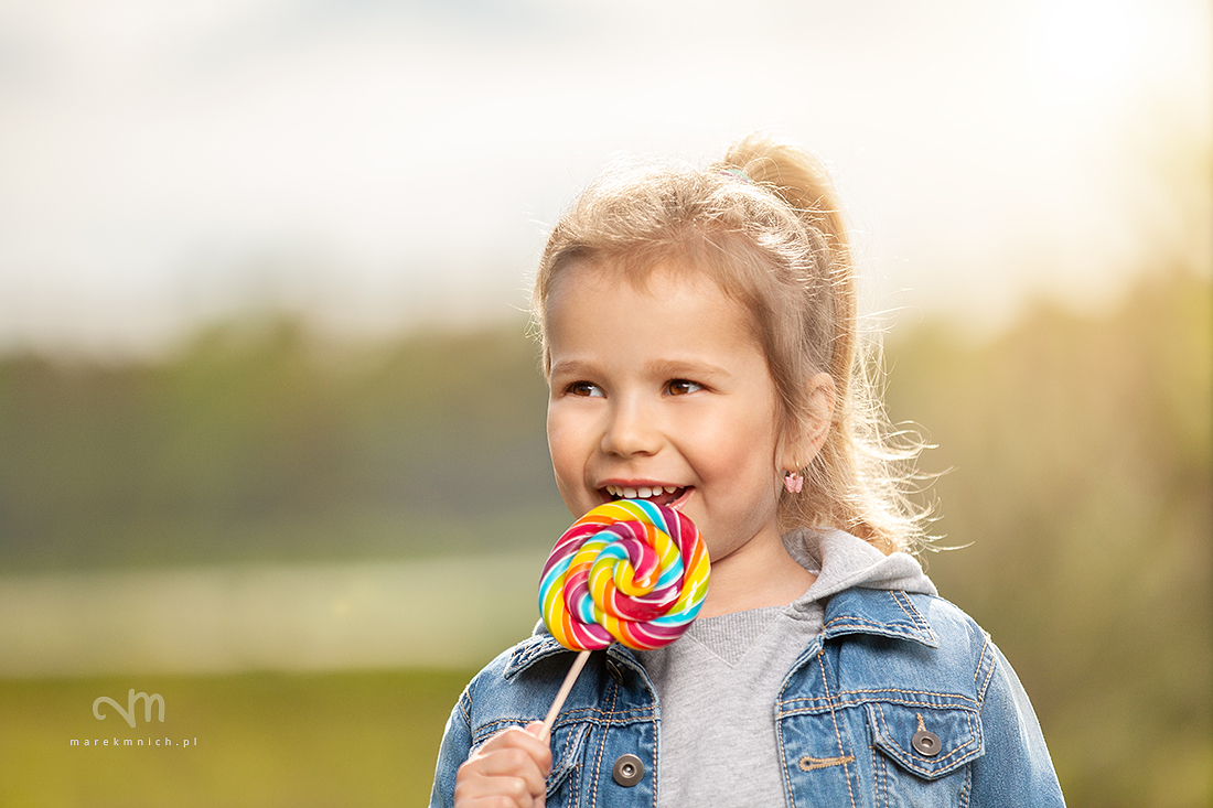 Smiling little girl with lollipop