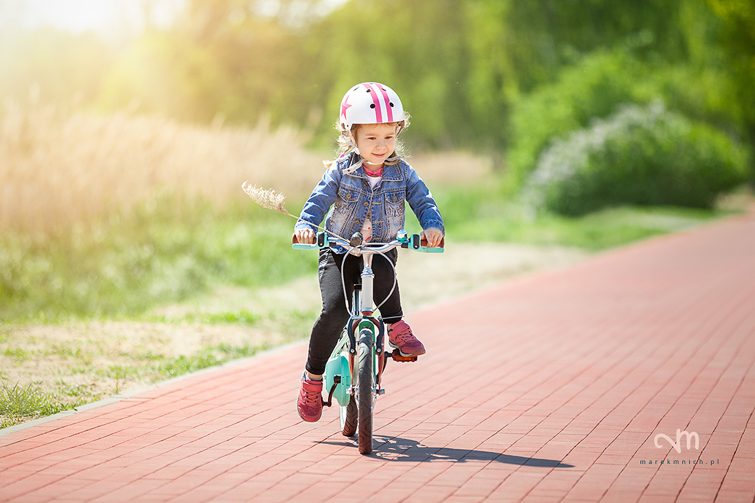 Cure little girl riding on bicycle